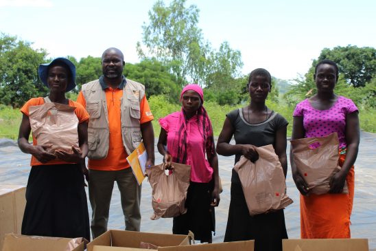 Mr Wilson Muzvondiwa from UNFPA poses for a photo with some of the preganant women who had received the food packages in Rushinga (Pic by Michael Gwarisa)