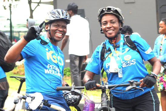 Zimmy Kanyemba smiles as he poses with Dr. Martina Kaome, an eye specialist who encouraged him to take up cycling.