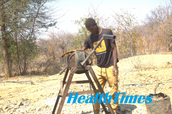 A young artisanal miner operates a lever at a mine shaft in Gokwe, Zimbabwe, highlighting the risks faced by children working in unsafe mining environments.